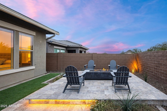 patio terrace at dusk with a fire pit