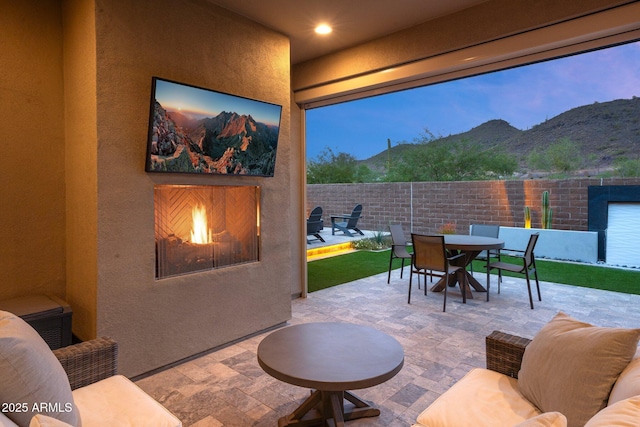 view of patio featuring exterior fireplace