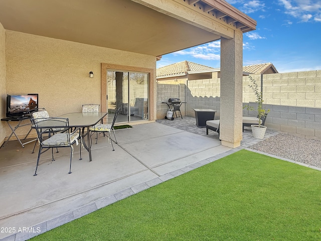 view of patio / terrace featuring a fenced backyard, grilling area, and outdoor dining space