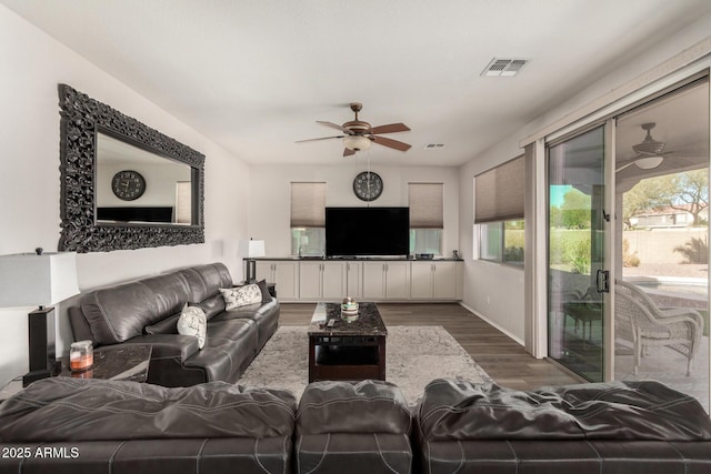 living room featuring dark hardwood / wood-style flooring and ceiling fan