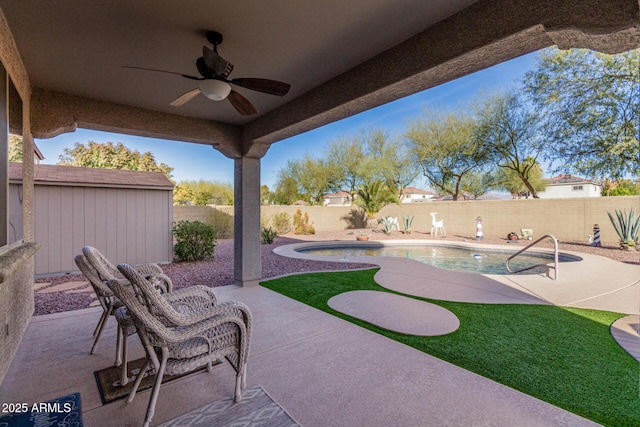 view of patio / terrace with a fenced in pool and ceiling fan