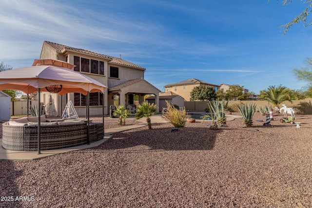 rear view of house with a patio area, an outdoor hangout area, and a storage unit