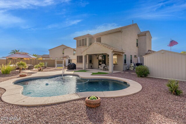 view of pool with a patio and a storage shed