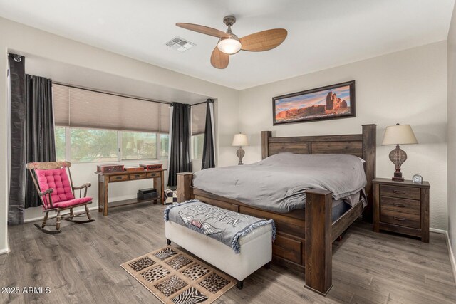 bedroom with light hardwood / wood-style flooring and ceiling fan