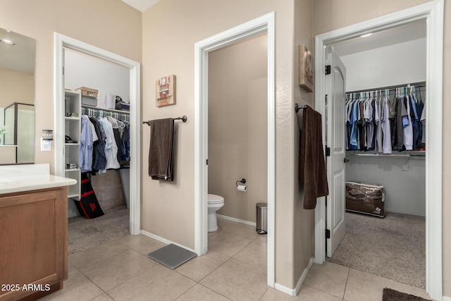 bathroom featuring tile patterned floors, vanity, and toilet