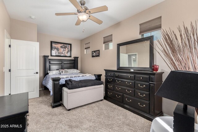 bedroom featuring light colored carpet and ceiling fan