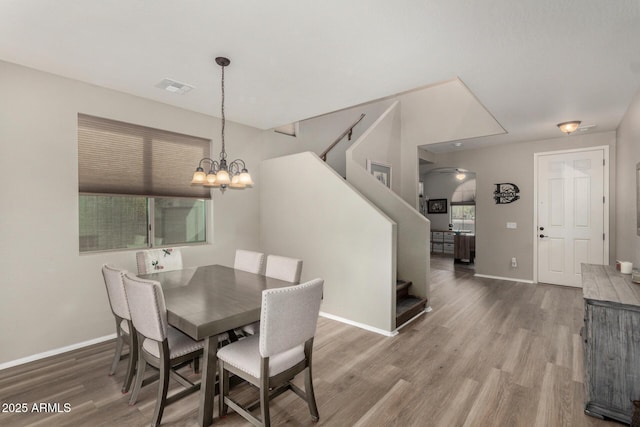 dining room featuring hardwood / wood-style floors and an inviting chandelier