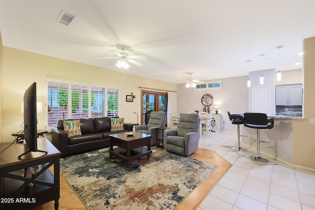 tiled living room with ceiling fan