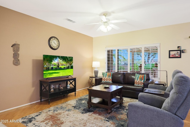 living room with wood-type flooring and ceiling fan