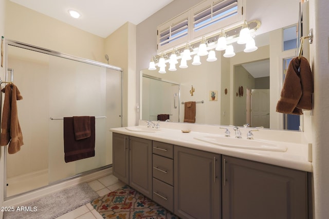 bathroom featuring vanity, tile patterned floors, and a shower with shower door