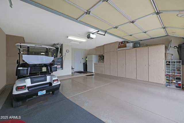 garage featuring a garage door opener and white fridge