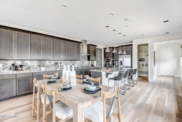 dining space with light wood-type flooring