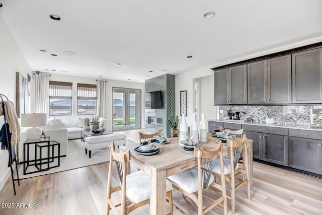 dining area featuring a fireplace and light hardwood / wood-style floors