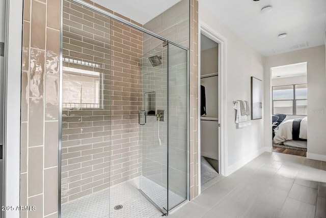 bathroom featuring a shower with door