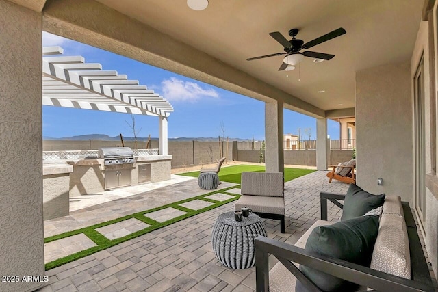 view of patio / terrace featuring ceiling fan, grilling area, a mountain view, and area for grilling