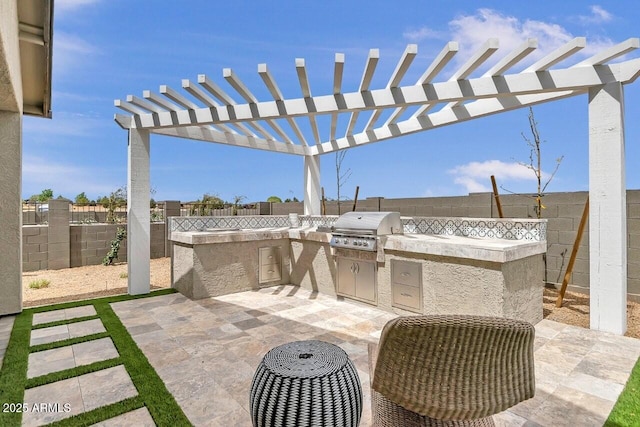 view of patio / terrace with an outdoor kitchen, grilling area, and a pergola