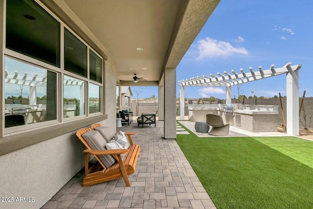 view of patio / terrace with ceiling fan, an outdoor kitchen, a pergola, and area for grilling