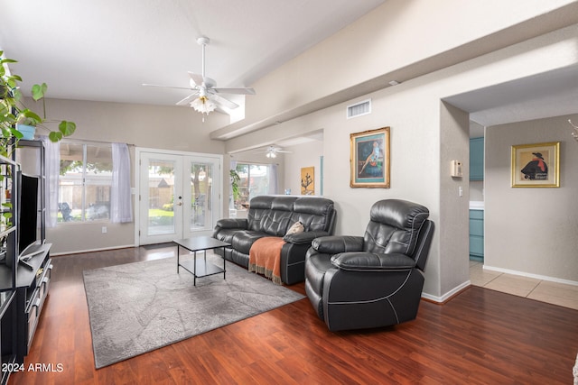 living room with plenty of natural light, dark wood-type flooring, and french doors