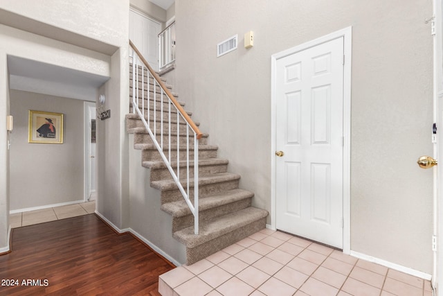 staircase featuring hardwood / wood-style flooring