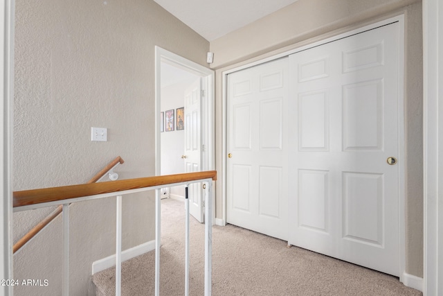 corridor with light colored carpet