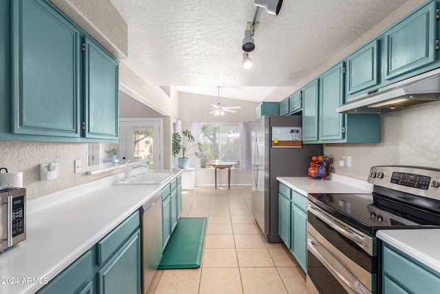 kitchen with blue cabinetry, ceiling fan, sink, exhaust hood, and appliances with stainless steel finishes