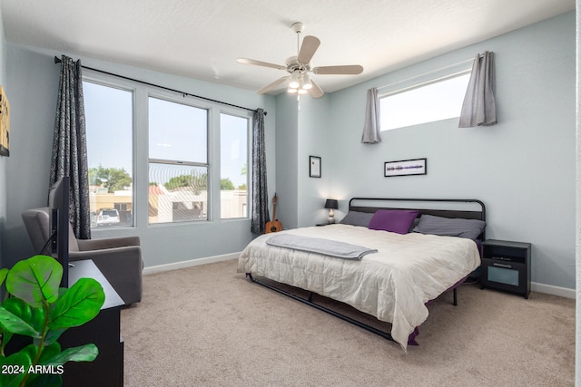 bedroom with carpet flooring, multiple windows, and ceiling fan