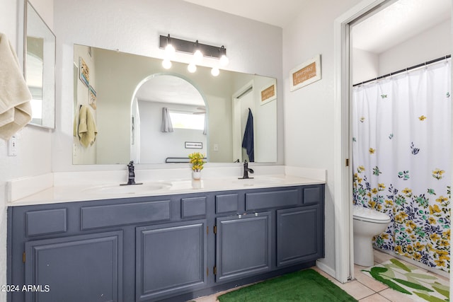 bathroom with tile patterned flooring, vanity, and toilet