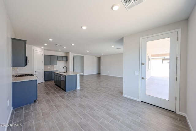 17716 W Fulton St, Goodyear, AZ 85338 - kitchen with visible vents, baseboards, open floor plan, light countertops, and a sink