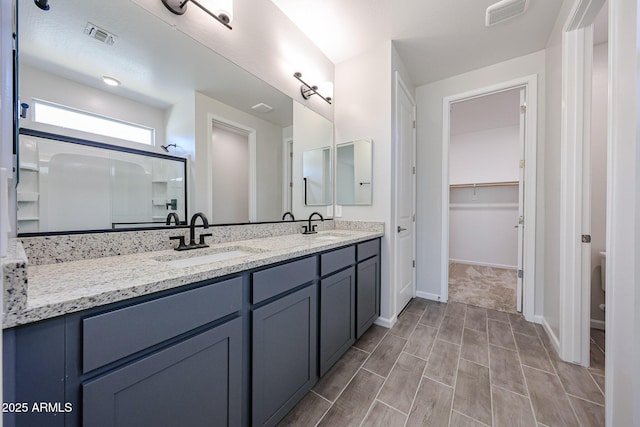 17716 W Fulton St, Goodyear, AZ 85338 - bathroom featuring a sink, an enclosed shower, double vanity, and visible vents