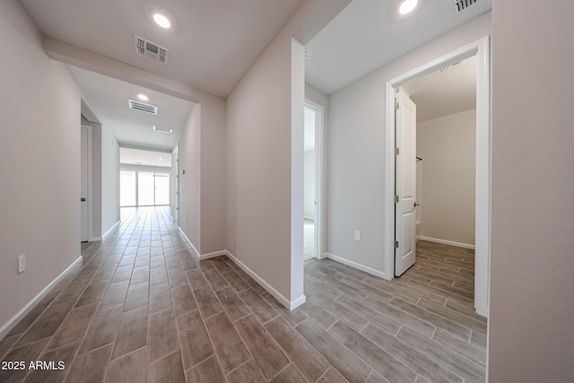 17716 W Fulton St, Goodyear, AZ 85338 - hallway with baseboards, visible vents, and wood finished floors