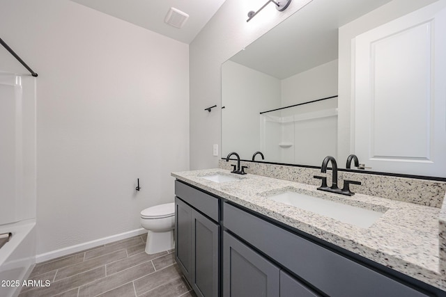 17716 W Fulton St, Goodyear, AZ 85338 - full bathroom with a sink, baseboards, toilet, and double vanity