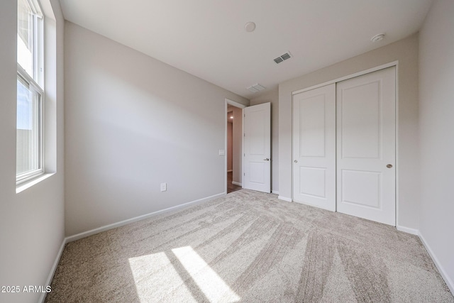 17716 W Fulton St, Goodyear, AZ 85338 - unfurnished bedroom with carpet flooring, visible vents, and multiple windows