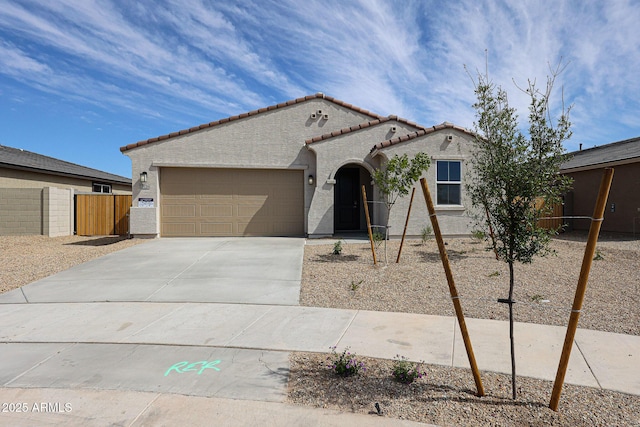 17716 W Fulton St, Goodyear, AZ 85338 - view of front facade with a garage, fence, stucco siding, a tiled roof, and concrete driveway
