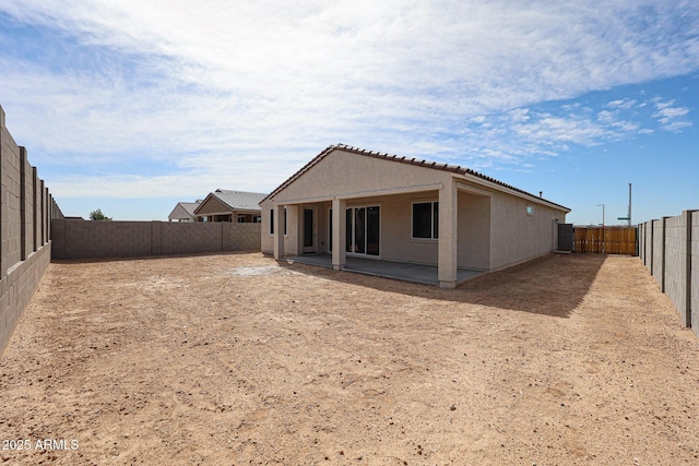 17716 W Fulton St, Goodyear, AZ 85338 - rear view of house featuring a fenced backyard, stucco siding, a patio area, and a tiled roof