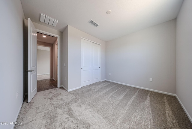 17716 W Fulton St, Goodyear, AZ 85338 - unfurnished bedroom featuring baseboards, carpet, a closet, and visible vents