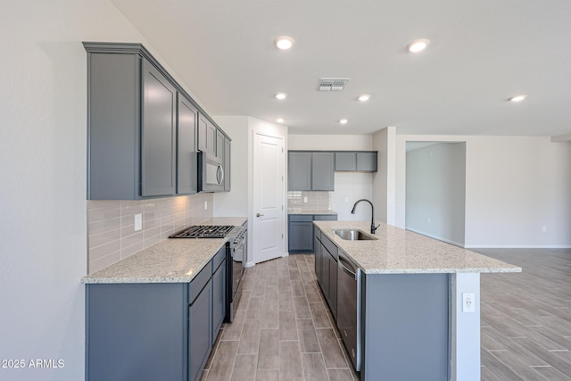 17716 W Fulton St, Goodyear, AZ 85338 - kitchen featuring a sink, wood finish floors, stainless steel appliances, and visible vents