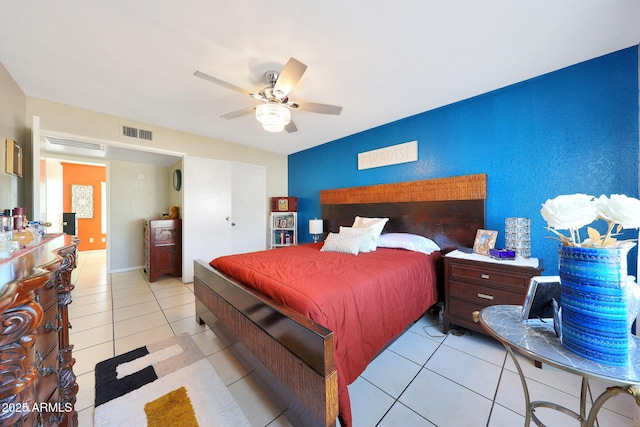 tiled bedroom featuring visible vents and a ceiling fan