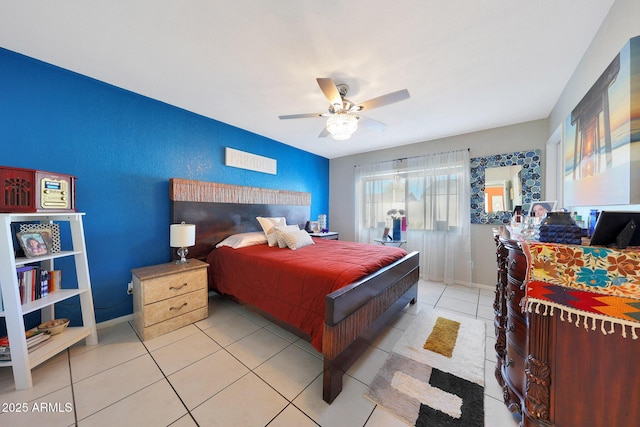 bedroom with a ceiling fan, light tile patterned flooring, and baseboards