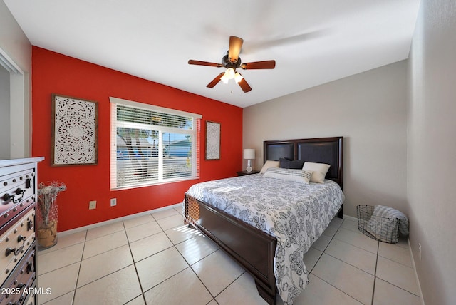 bedroom with light tile patterned floors, ceiling fan, and baseboards