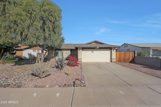 single story home with stucco siding, driveway, an attached garage, and fence