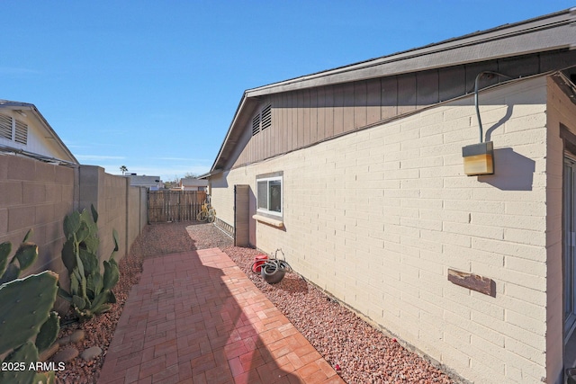 view of home's exterior featuring a fenced backyard and a patio