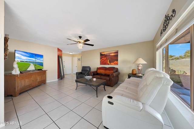 living room featuring ceiling fan, baseboards, and light tile patterned floors