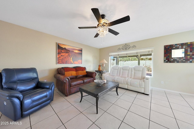 living area featuring light tile patterned floors, baseboards, and a ceiling fan