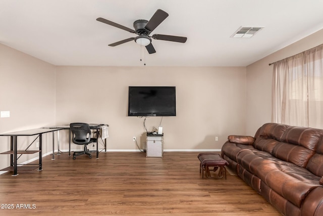 living area with visible vents, baseboards, ceiling fan, and wood finished floors