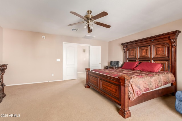 bedroom featuring visible vents, light colored carpet, baseboards, and ceiling fan