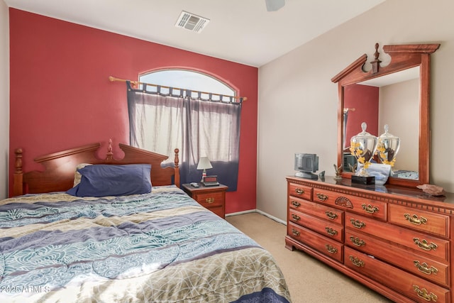 bedroom with light carpet, visible vents, and ceiling fan