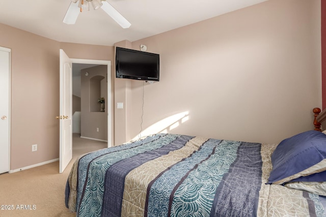 carpeted bedroom with a ceiling fan and baseboards