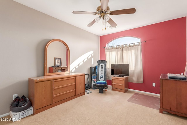 office with visible vents, carpet floors, baseboards, and a ceiling fan