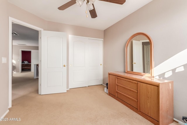 bedroom with ceiling fan, a closet, and light carpet