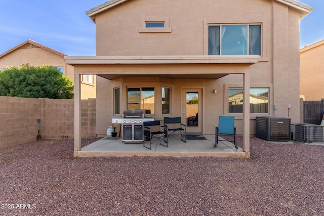 back of house featuring stucco siding and a patio area